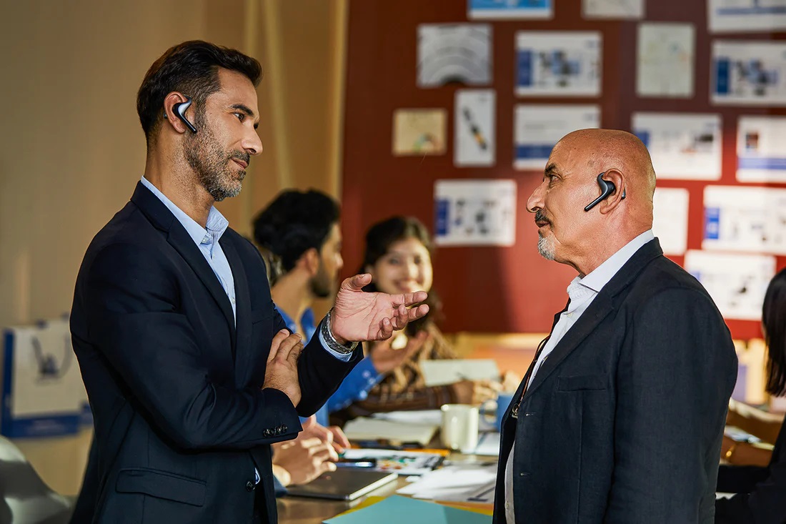 Two people using the Timekettle W4 Pro during a live conversation